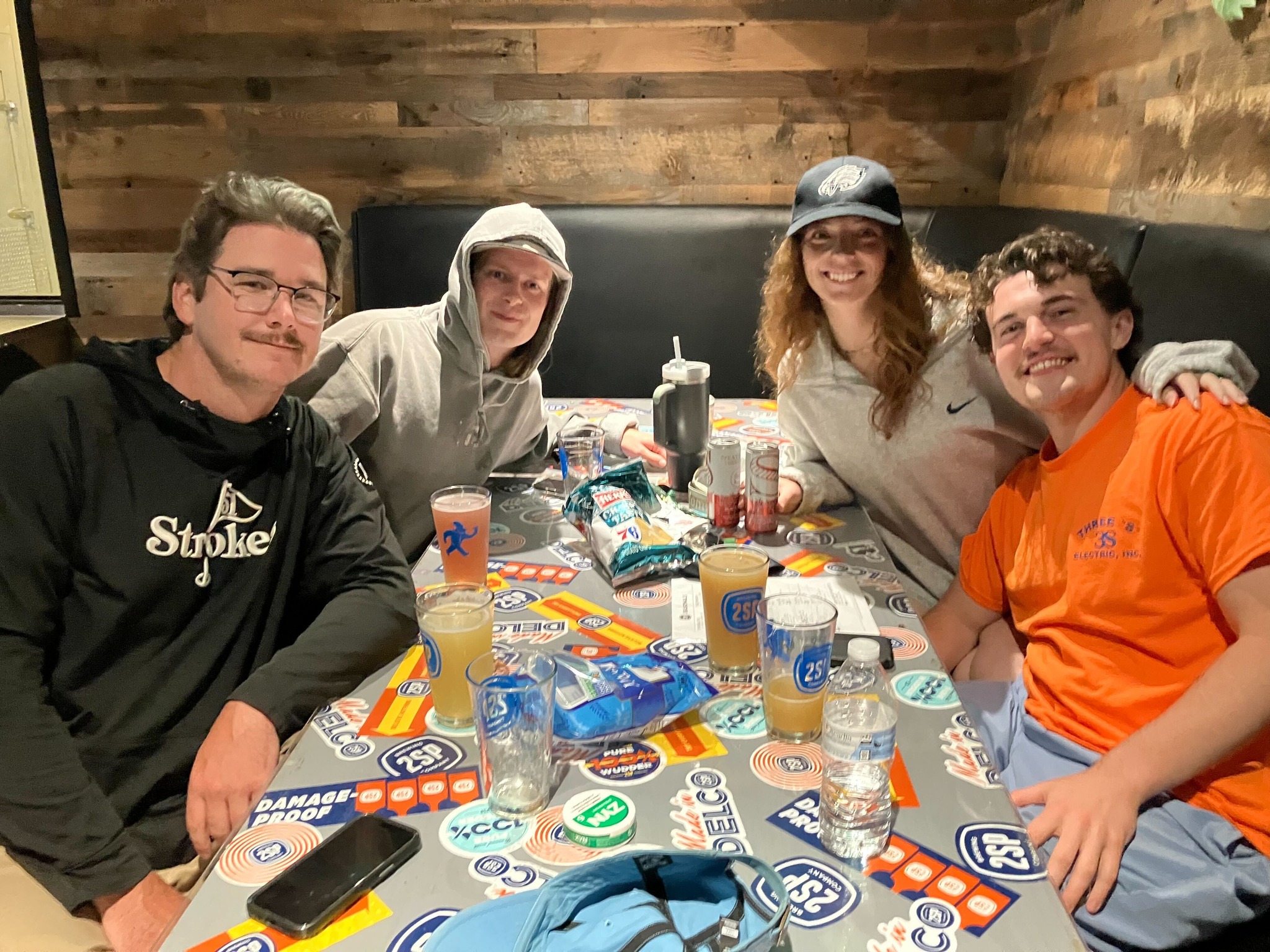Friends celebrating a Points Up trivia win at Stoke Coal Fire Pizza