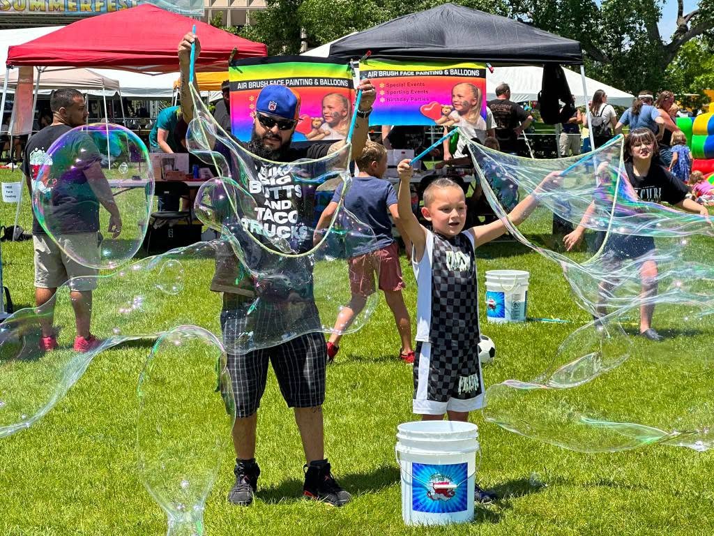 Kids making giant bubbles at a Points Up bubble party