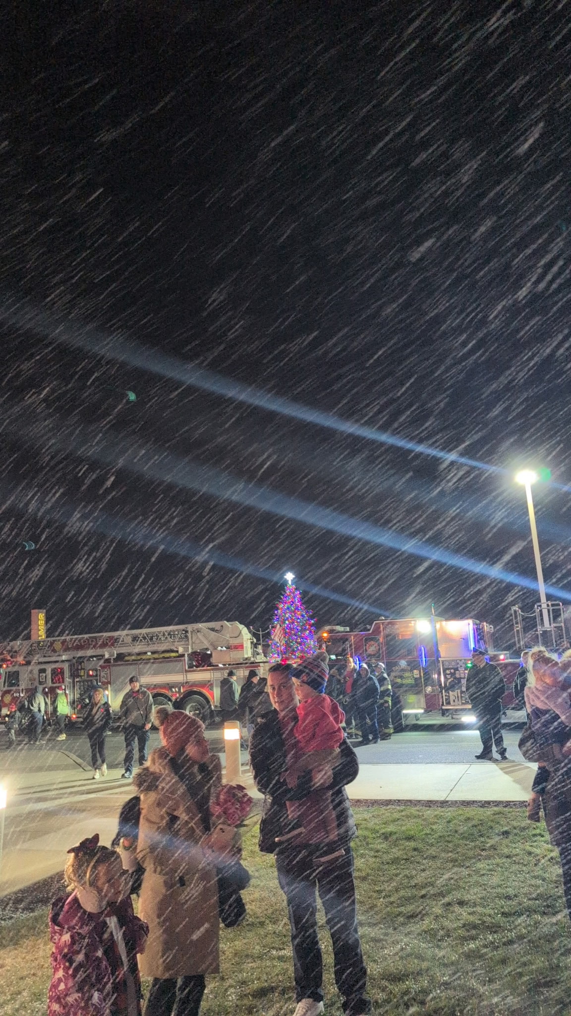Snow falling on a tree lighting event by Points Up